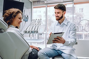 dentist showing a patient information on a tablet 