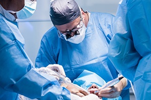 group of dentists performing dental implant surgery 