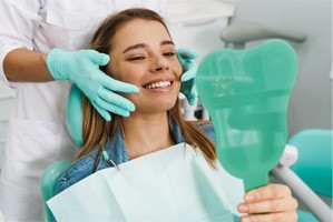 patient smiling after getting dental bridge in Gainesville