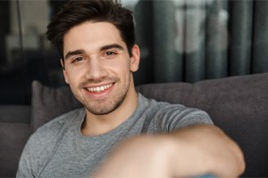 patient smiling after getting dental bridge in Gainesville 