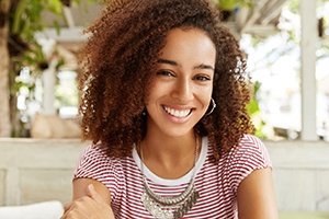 woman smiling after getting dental crown in Gainesville