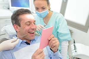 patient smiling while getting dental crown in Gainesville