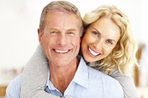 older couple smiling with dental implants in Gainesville