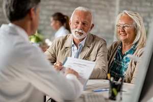 elderly couple at a dental implant consultation