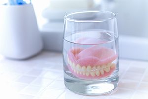 Dentures in Gainesville soaking in a solution