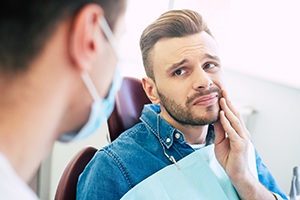 Patient with toothache looking at dentist