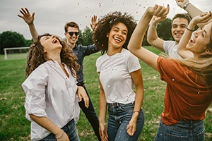 Group of people outside smiling and celebrating