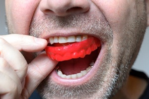 man wearing a red mouthguard