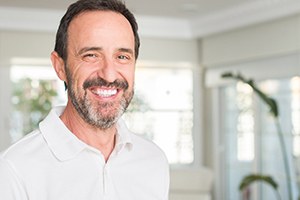 a man smiling after visiting dental implant dentist in Gainesville