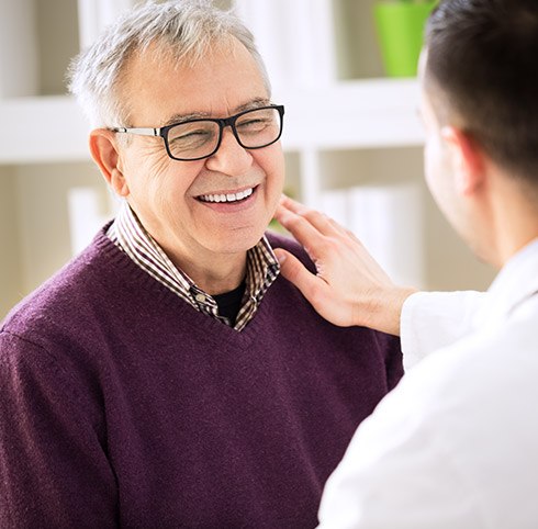 Smiling senior man at dentist's office