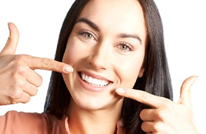 woman pointing to her teeth