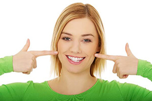 woman pointing at her smile