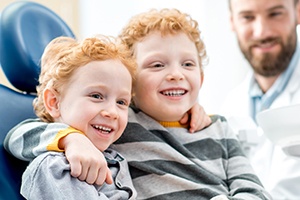 Two young boys in dental chair together