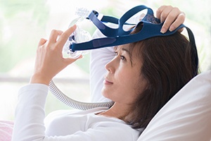 Woman placing CPAP system