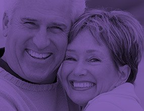 Smiling older couple highlighted purple