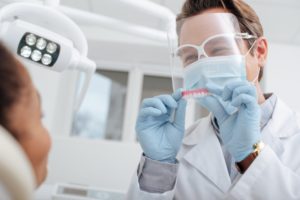 Dentist in Gainesville wearing protective gear 