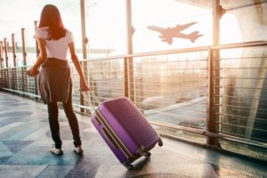 a woman with a suitcase at the airport