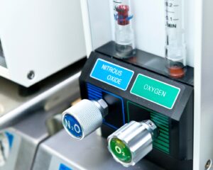 Nitrous oxide and oxygen controls on a medical machine.
